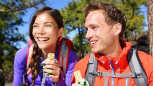 People eating hiking snacks.