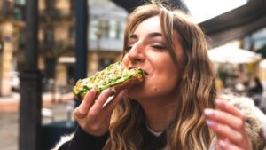 Happy woman enjoys avocado toast