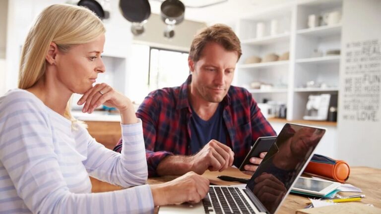 A couple budgeting at home in their kitchen.