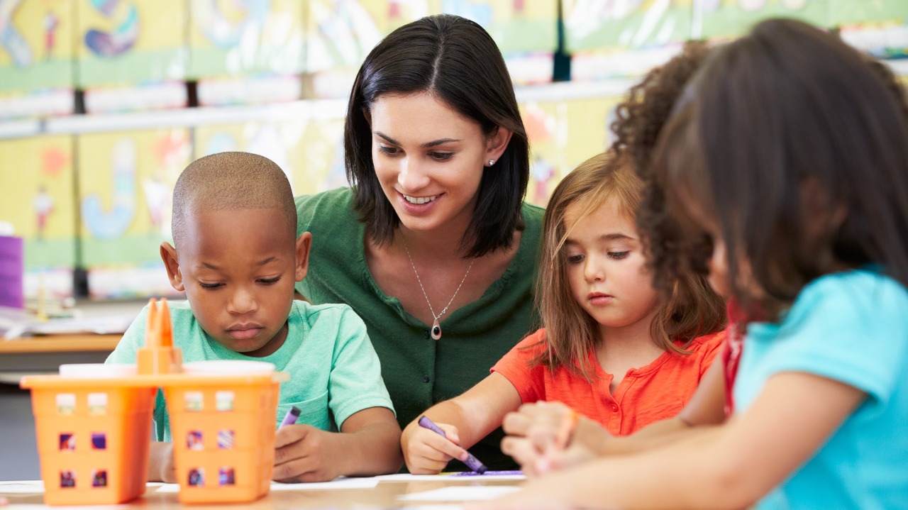 Group Of Elementary Age Children In Art Class With Teacher