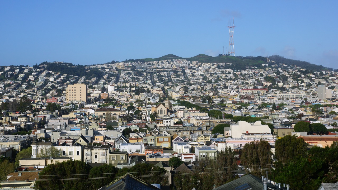 Aerial view of Houses, Cars. Cityscape, streets, and mountians of San Francisco in Potrero Hill Neighborhood with power-lines and cars parked on street.