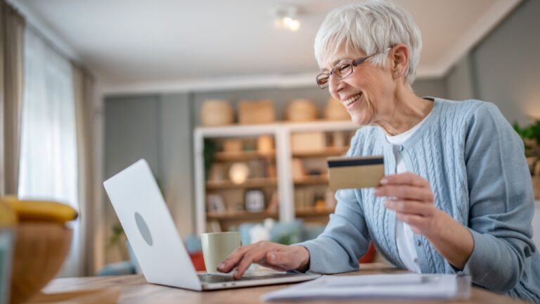 senior woman shopping online with credit card